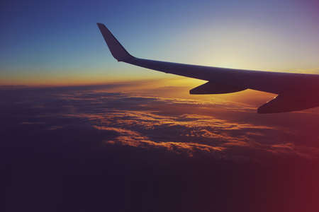 View from an airplane in the sky at sunsetの写真素材