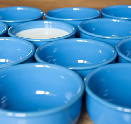bowls pattern  one of them is full on milkの写真素材