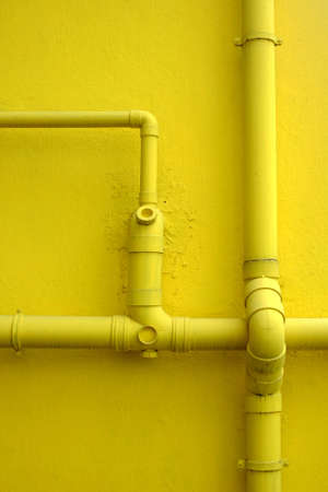 Yellow wall and few pipelinesの写真素材