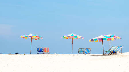 colorful umbrellas and chair on the beachの写真素材