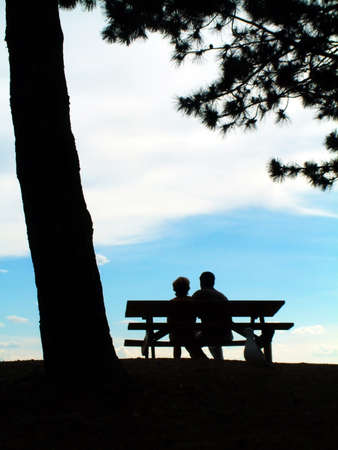 The shadow of senior couple near the tree in sunny dayの写真素材