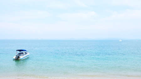 One motor boat is parked near beach with light blue sky and seaのeditorial素材