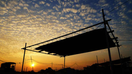 cloudscape and village at sunsetの写真素材