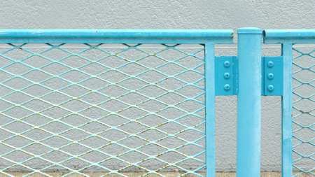 Blue metal chainlink fence in the streetの写真素材