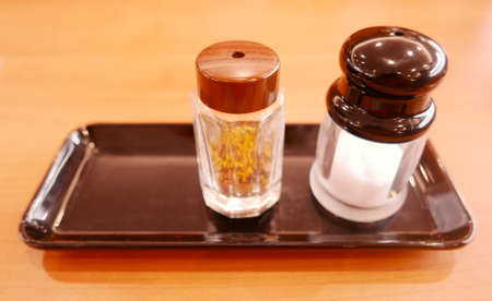 Salt shaker on the black trayの写真素材