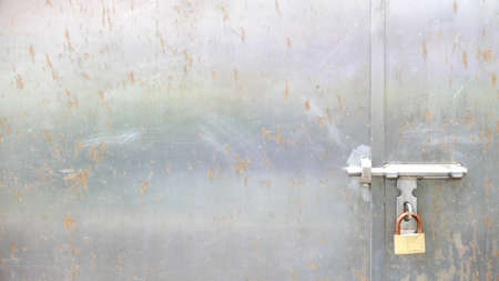Old silver metal door with lockの写真素材