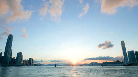 The sun is in between Hong Kong island and Kowloon at sunsetのeditorial素材