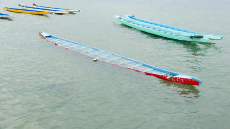 The half of red dragon boat is sinked into the water
