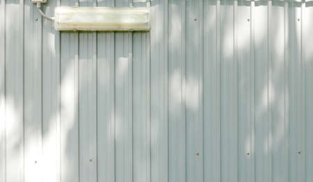 Corrugated aluminium plate with lampの写真素材