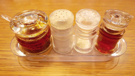 salt, pepper shaker on wooden tableの写真素材