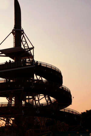 Silhouette building and people in the outdoor park at sunsetの写真素材