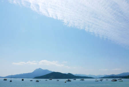 Fishing and motor boats with blue sky and clouds