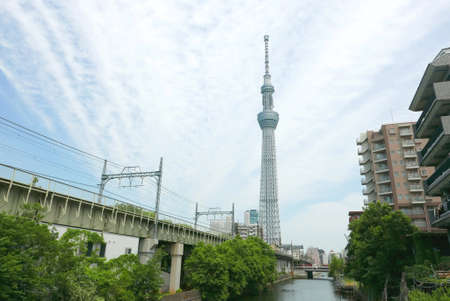 Japan tower, building river, train track and green trees with sky