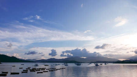 Boat, lake, mountain, blue sky and the cloudsの写真素材