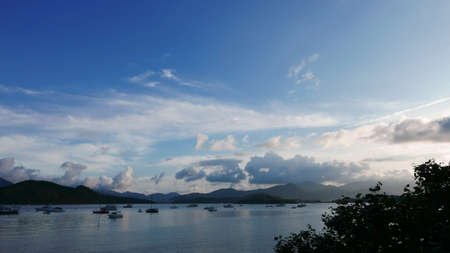 Boat, lake, mountain, blue sky and the cloudsの写真素材