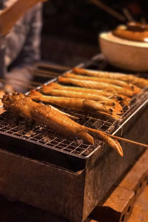 Outdoor barbecue chicken wing on the metal net grilledの写真素材