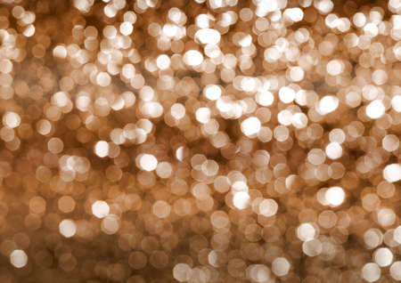 The golden bokeh glittering bright abstract backgroundの写真素材