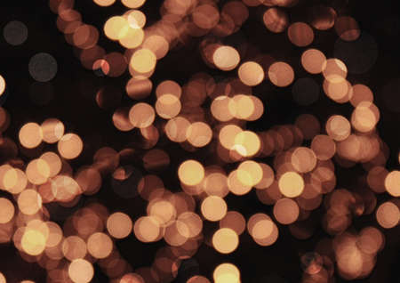 The golden bokeh glittering bright abstract backgroundの写真素材