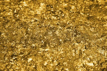 The golden pieces and sequins textured backgroundの写真素材
