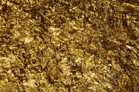 The golden pieces and sequins textured backgroundの写真素材