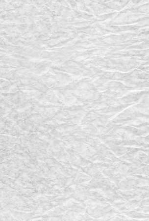 The White blank crumpled and grungy textured paper backgroundの写真素材