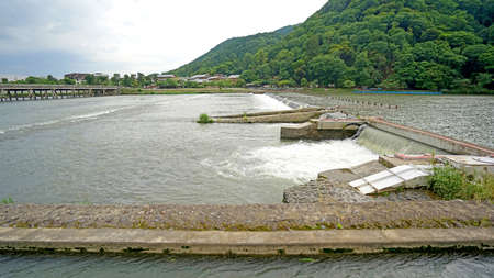 The mountain, wooden bridge rapid river in Japan Kyotoのeditorial素材