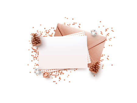 Empty memo and rose gold envelope  with Christmas decorations on white background