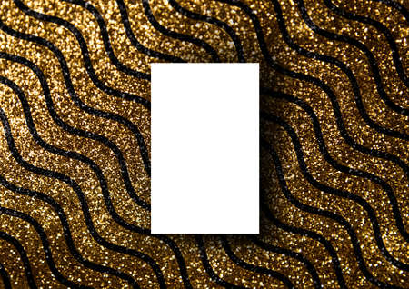 Business card  on gold glitter wavy line textured paper backgroundの写真素材