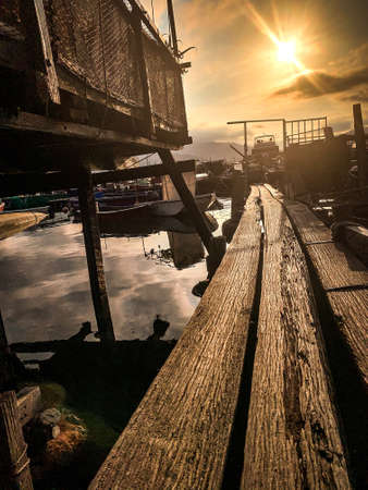 The fishing boats on the sea and wooden house in Hong Kong countrysideの写真素材
