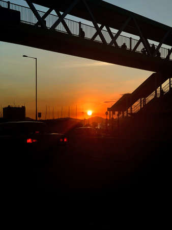 The silhouette of city bridge, road, car in Hong Kong downtown district at sunset