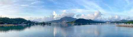The Hong Kong landscape panorama photography with clouds, sky, ocean, boat and mountainの写真素材