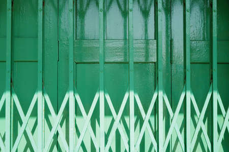 The horizontal traditional retro Hong Kong style green shop front building matel gate rolling door designの写真素材