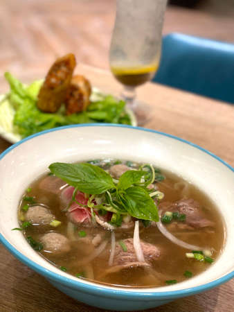 The delicious vietnamese food pho beef noodles in vietnam restaurant with side dish and cold drink...