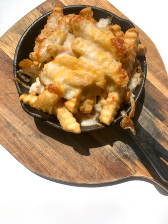 The top closeup of restaurant snack food french fries in the metal pan