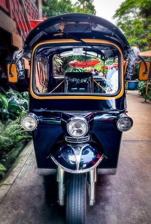 This colorful tuk-tuk is a popular mode of transportation in Thailand, often seen in busy urban...