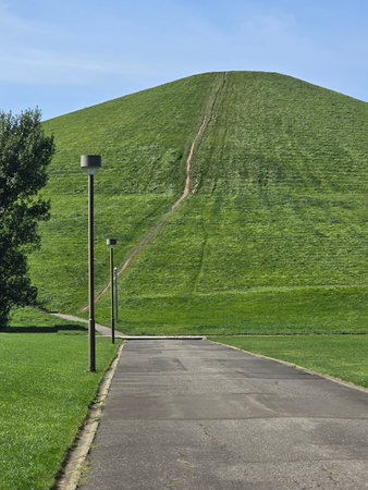 A beautiful landscape showcases a winding road, with rolling hills and a vibrant skyの写真素材