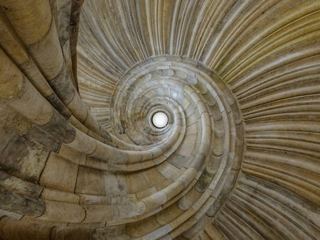 Old spiral stone staircase photographed from below showing skilled craftmanship and design
