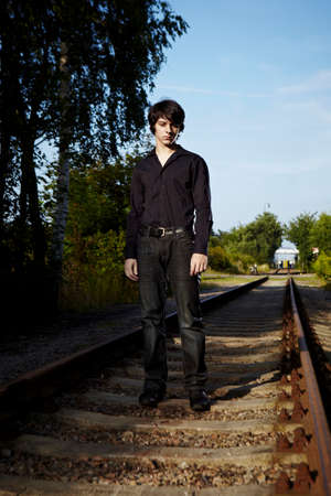 Moody young man acting his emotions on outdoor location when posing for illustration photos.の写真素材