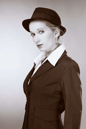 Mafia old style fashion studio portrait of blonde young pretty woman.の写真素材