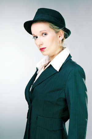 Mafia old style fashion studio portrait of blonde young pretty woman.の写真素材