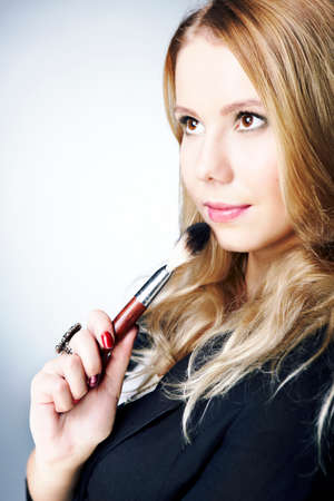 Make up artist - studio portrait of a woman with make up and brushes.の写真素材