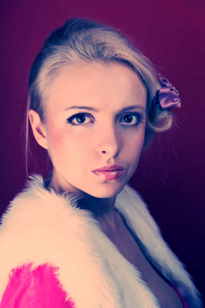 Fashion retro home style portrait of woman posing on interior location like an fancy housewife.の写真素材