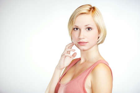Blonde girl posing in studio for portrait photos.の写真素材
