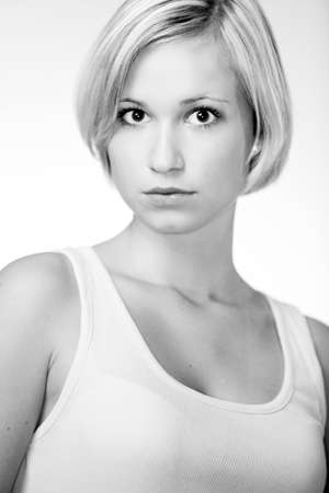Blonde young pretty girl posing in studio for portrait photos in white A shirtの写真素材