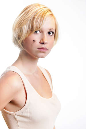 Blonde young pretty girl posing in studio for portrait photos in white A shirtの写真素材
