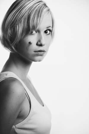 Blonde young pretty girl posing in studio for portrait photos in white A shirtの写真素材