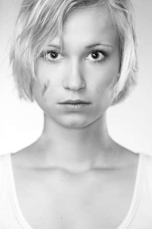 Blonde young pretty girl posing in studio for portrait photos in white A shirtの写真素材