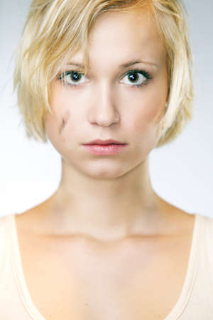 Blonde young pretty girl posing in studio for portrait photos in white A shirtの写真素材