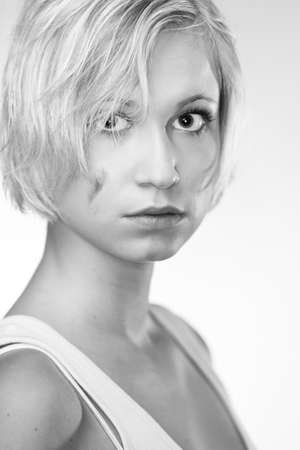 Blonde young pretty girl posing in studio for portrait photos in white A shirtの写真素材