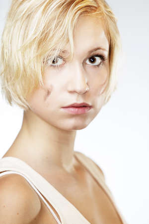 Blonde young pretty girl posing in studio for portrait photos in white A shirtの写真素材